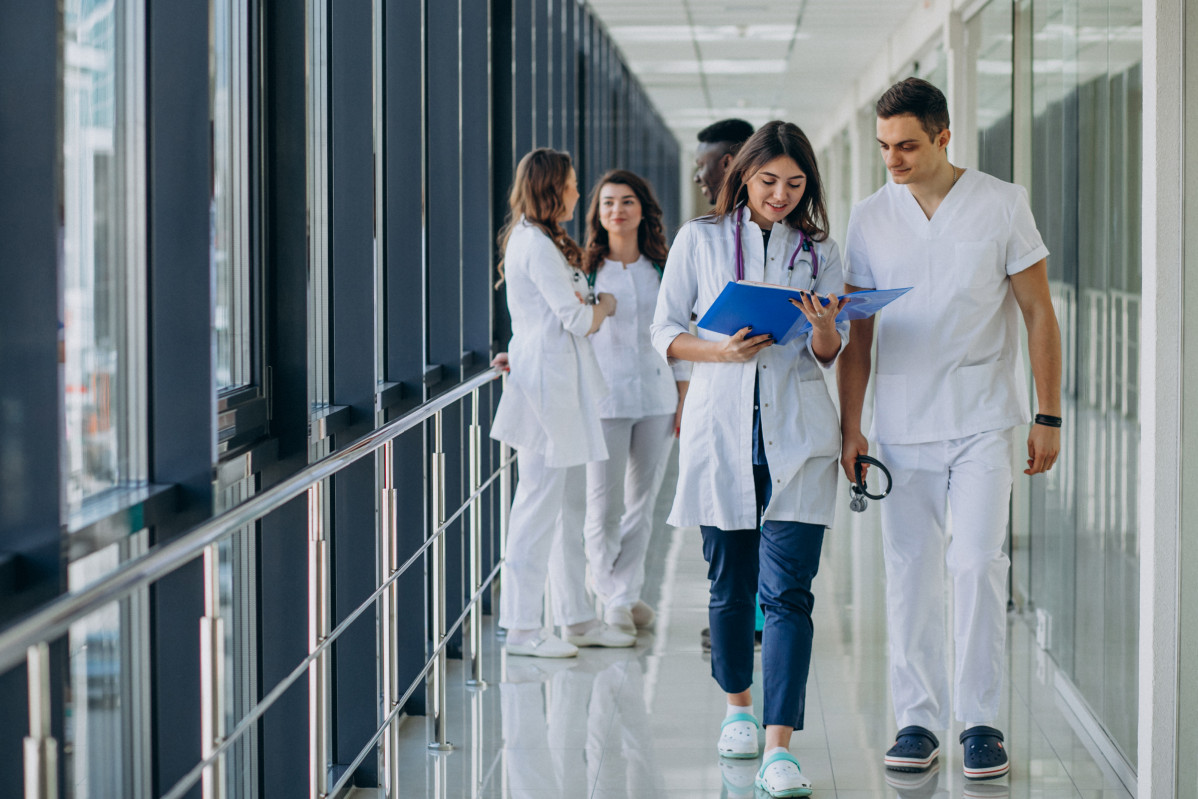 Team of young specialist doctors standing in the corridor of the hospital